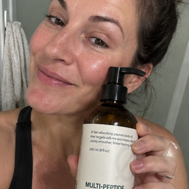 Peptide body oil being massaged into an upper arm